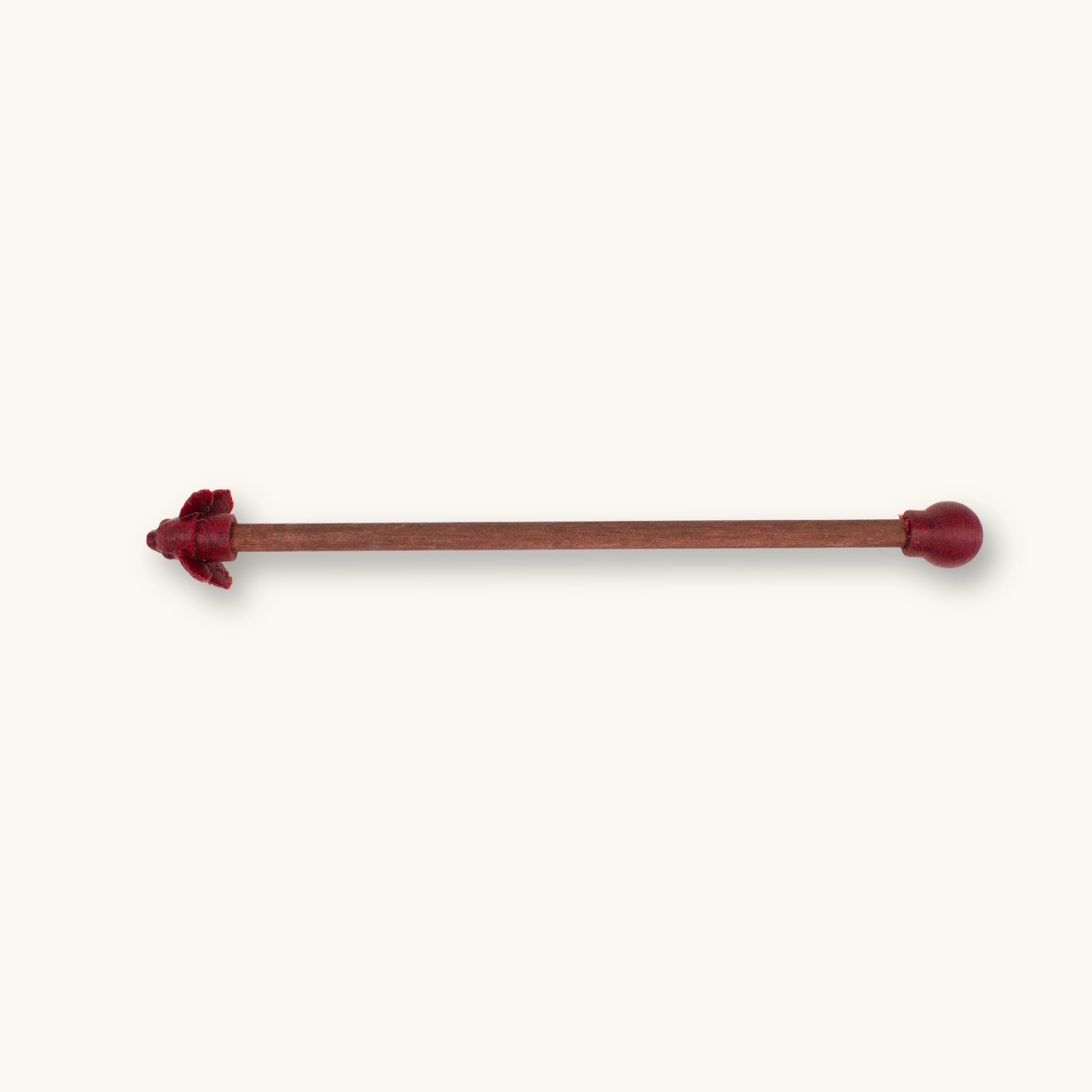 A single maroon betta fish flare stick photographed on a natural background.