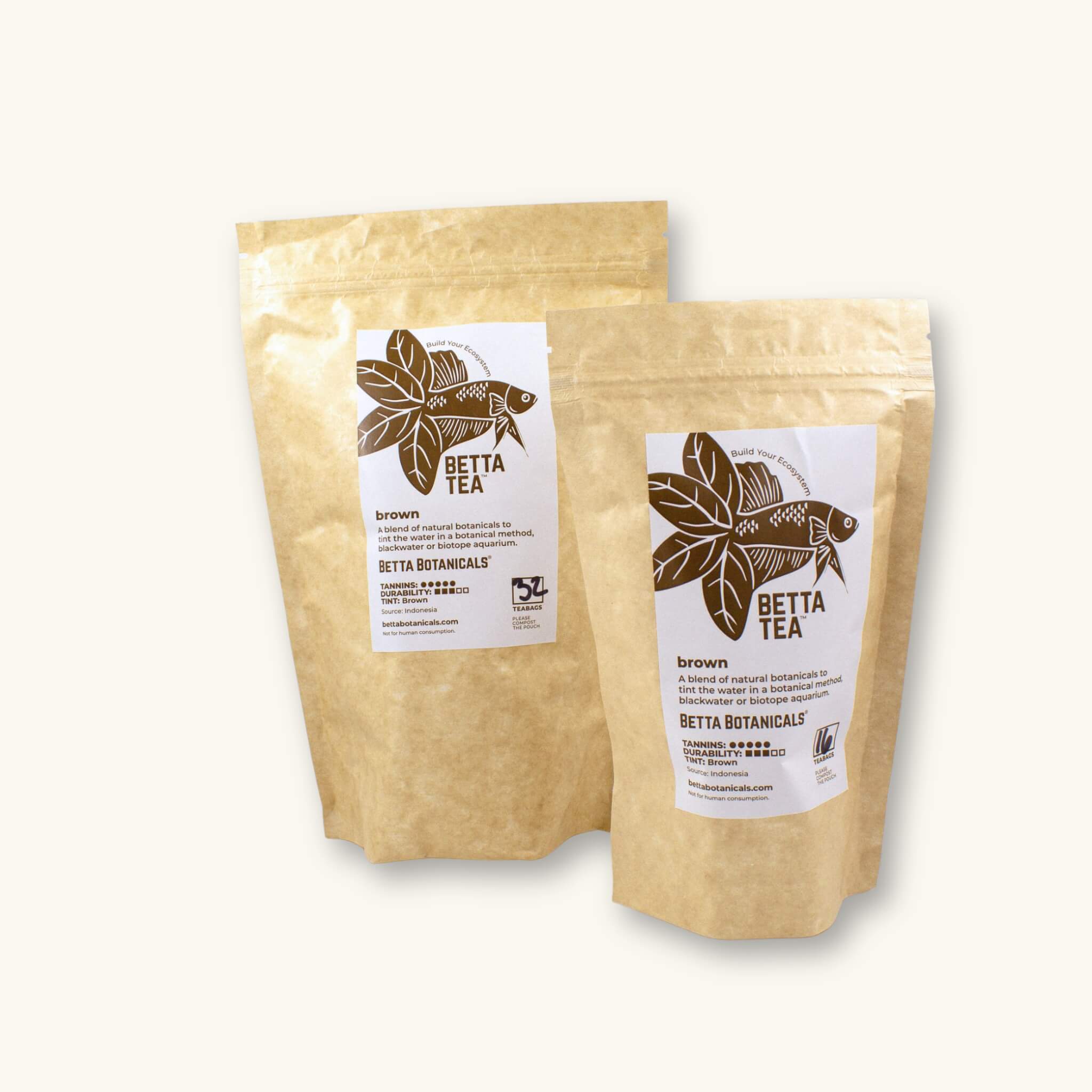 Kraft colored compostable pouchs of 32 and 16 count brown tinting tea bags, photographed against a natural background at Betta Botanicals.