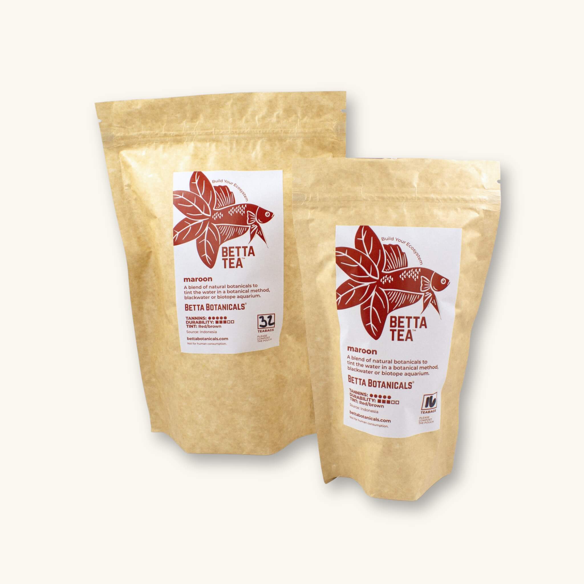 Kraft colored compostable pouchs of 32 and 16 count maroon tinting tea bags, photographed against a natural background at Betta Botanicals.