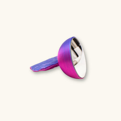 A blue and purple betta fish mirror for flaring, 3D printed and photographed on a natural background.