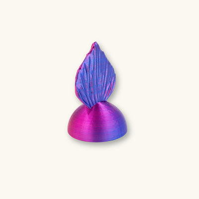 A two-tone blue and purple betta fish flare mirror, 3D printed and photographed on a natural background.