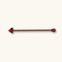 A single maroon betta fish flare stick photographed on a natural background.