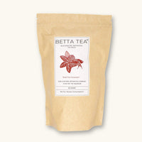 A kraft colored compostable pouch of maroon tinting tea bags containing high tannin botanicals to retint blackwater aquariums at Betta Botanicals.