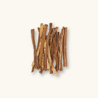 A collection of brown catappa bark sticks (Terminalia catappa) for blackwater aquariums, photographed on a natural background at Betta Botanicals.