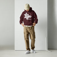 A model dressed in a maroon Betta Botanicals hoodie with the ‘Build Your Ecosystem’ logo, styled with neutral cargo pants.