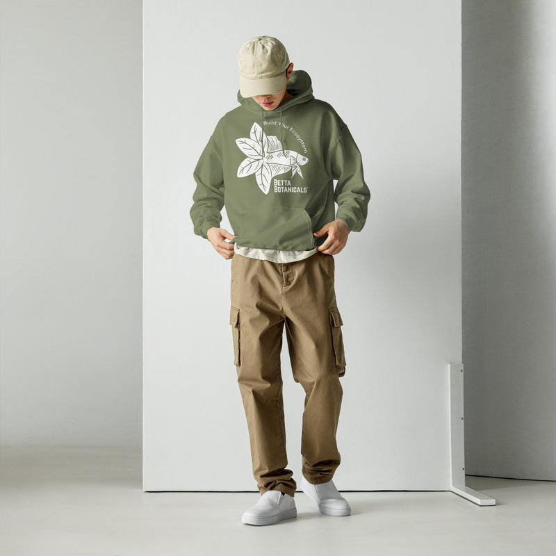 A model wearing a military green Betta Botanicals hoodie featuring the ‘Build Your Ecosystem’ logo, paired with khaki cargo pants.