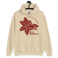 Unisex heavy-blend hoodie in sand beige with a maroon Betta Botanicals logo, highlighting a Betta fish illustration and the phrase ‘Build Your Ecosystem’.