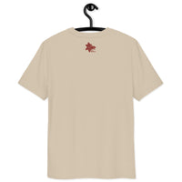 A beige organic cotton t-shirt featuring a small red Betta Botanicals logo with a fish and leaf graphic centered on the upper back.